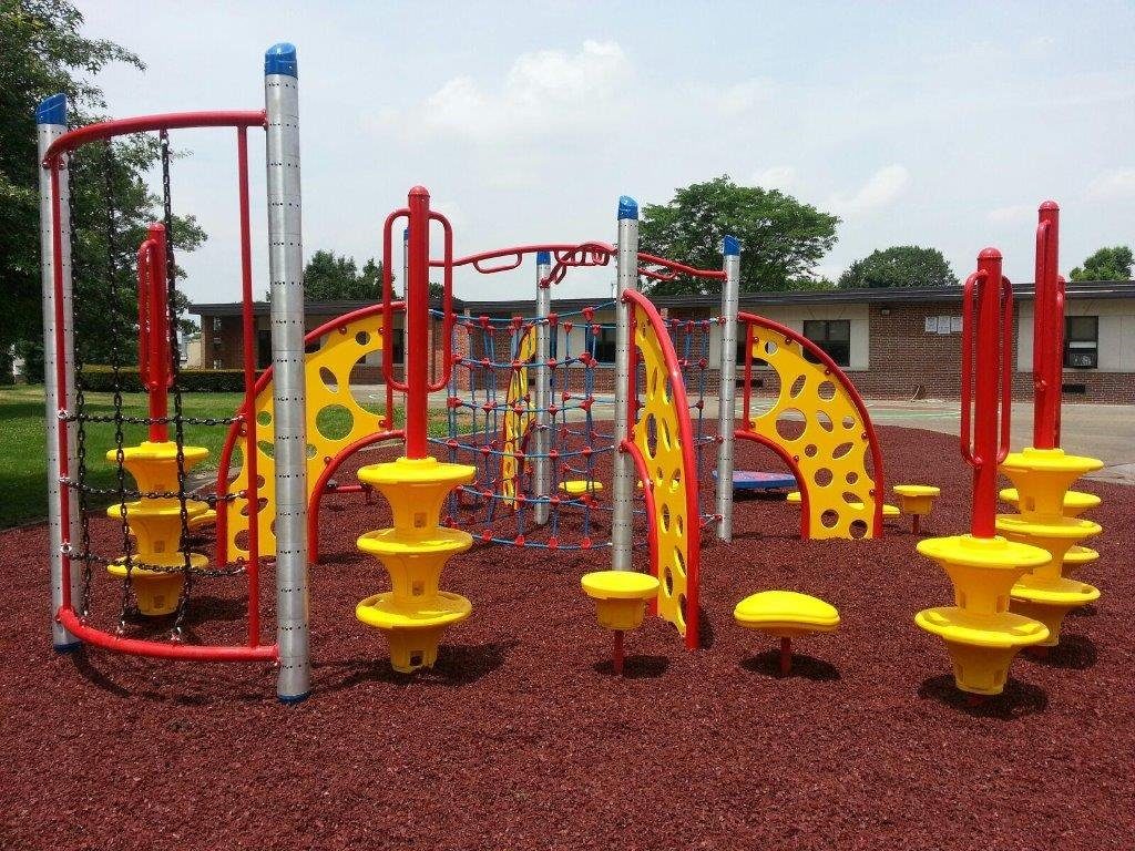 red and yellow playground on red mulch area