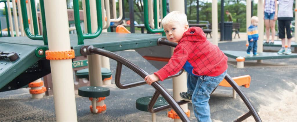 little boy climbing up playground ladder